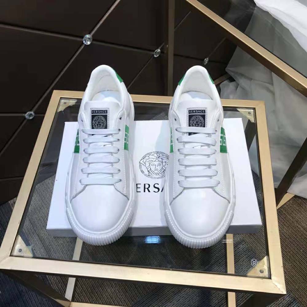 Close-up of gold Greca emblem on Versace Women A Classic Low Top Greca Sneakers-Green