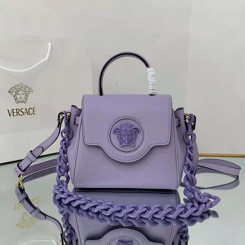 Close-up of gold Medusa hardware on Versace Women La Medusa Small Handbag purple leather