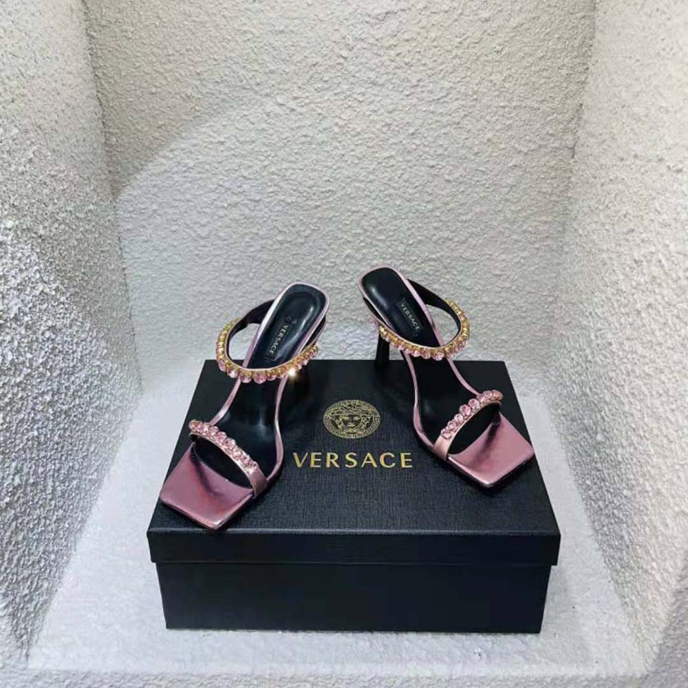 Close-up of pink leather and rhinestone details on Versace mules