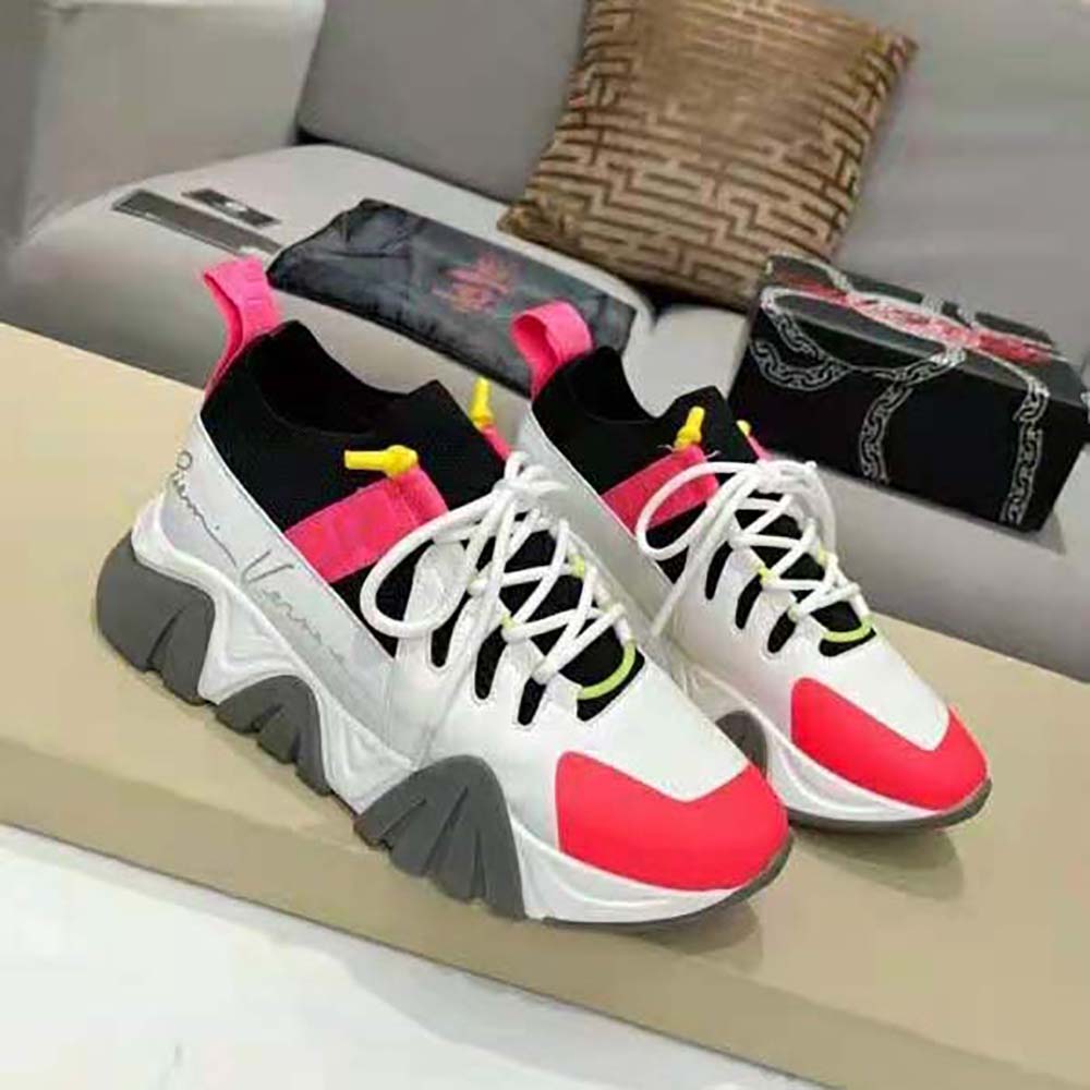 Close-up detail of gold Medusa emblem on pink Versace Women Squalo Knit Sneakers