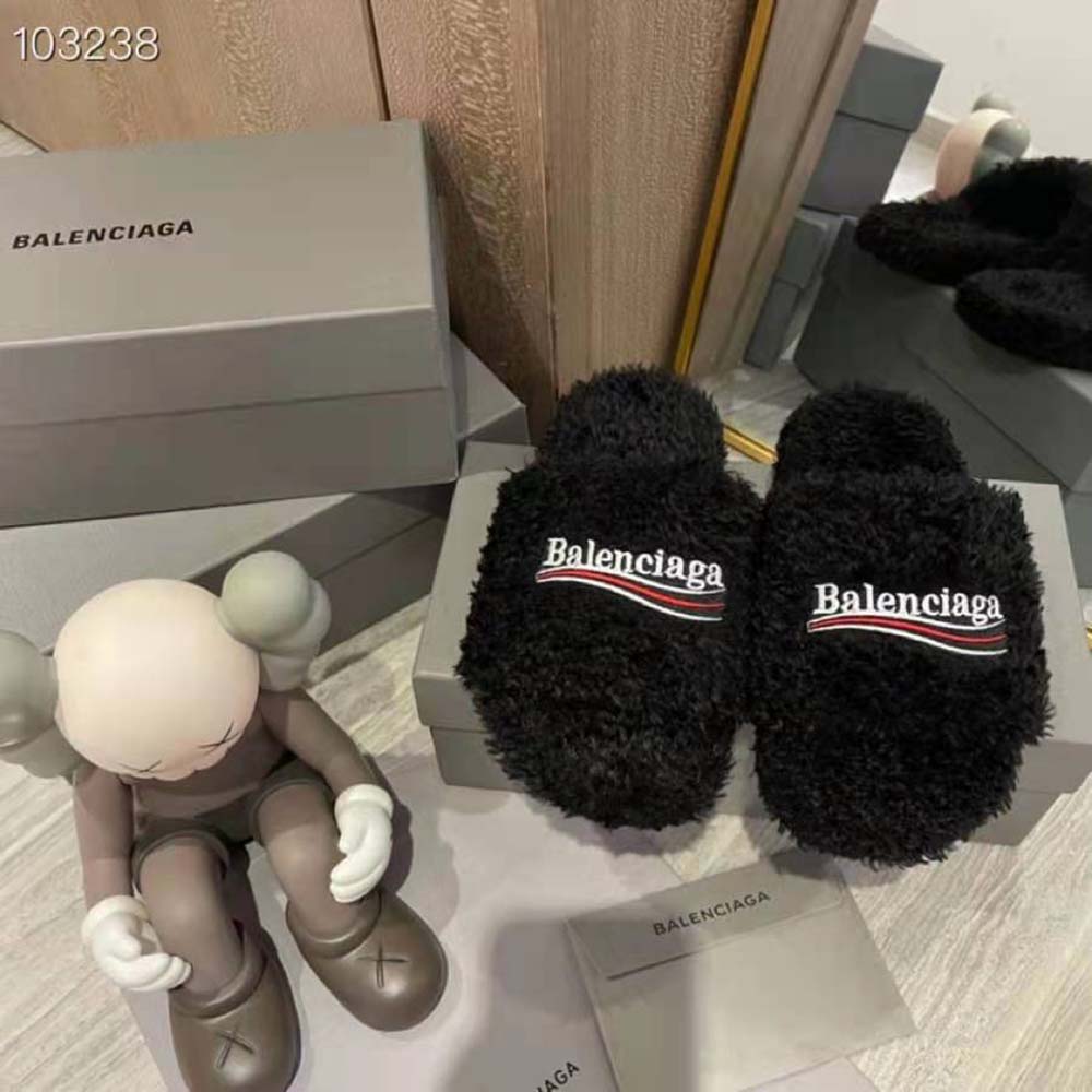 Close-up of white political campaign embroidery on Balenciaga furry slide sandal