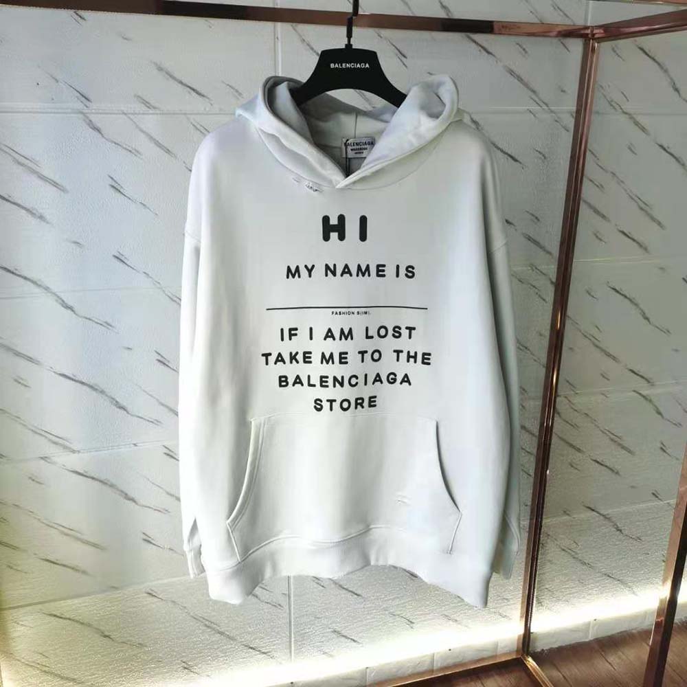 Close-up of Balenciaga oversized logo on white fleece hoodie chest