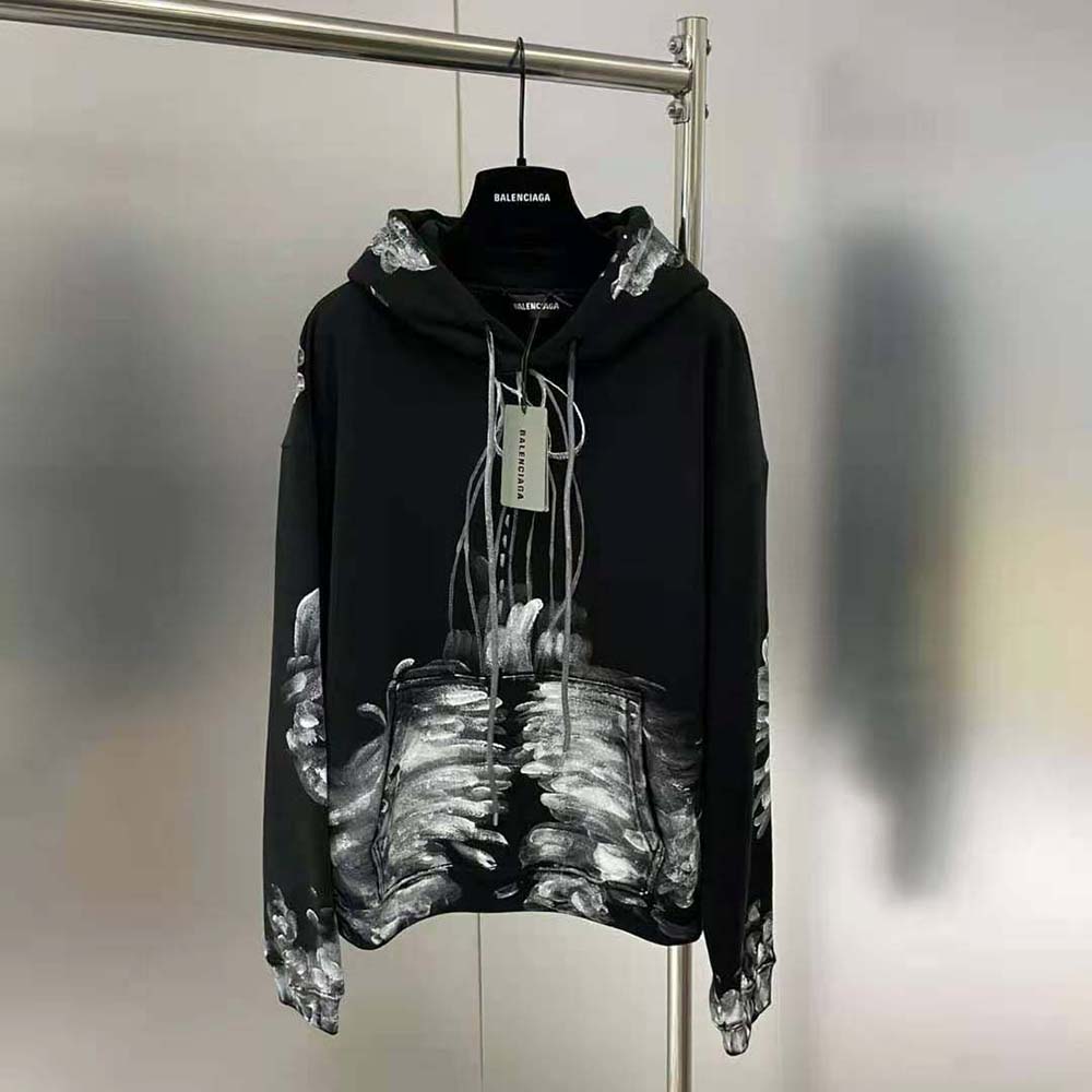 Close-up of Balenciaga logo detail on the black and white fitted hoodie