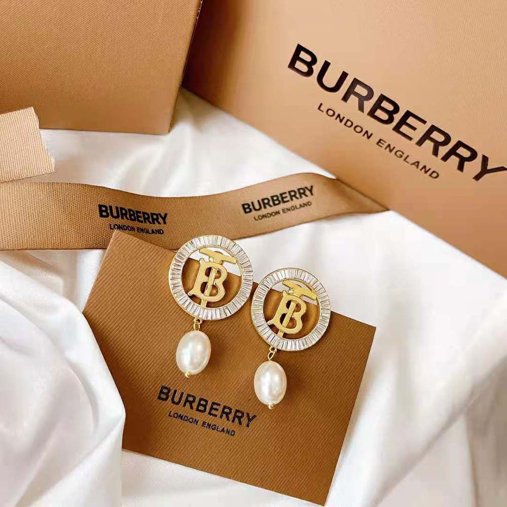 Side angle showing pearl and gold-plated monogram detail on Burberry earrings