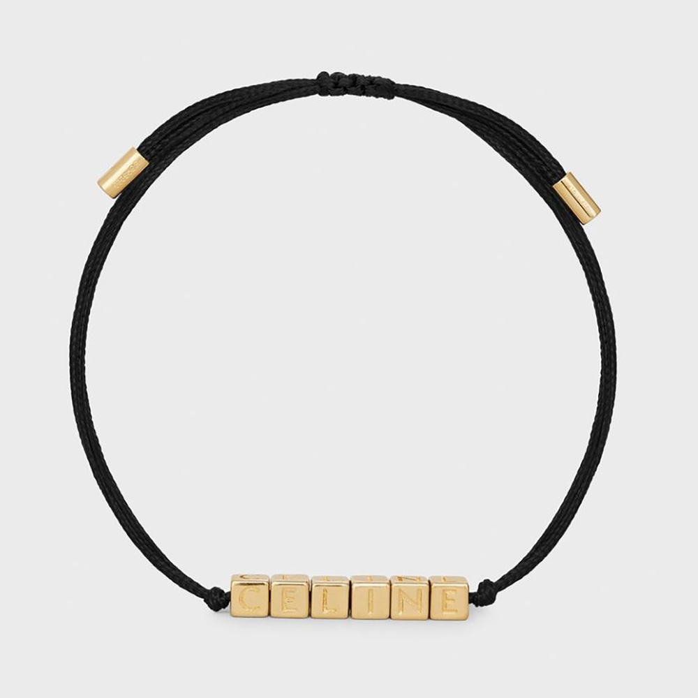 Close-up of Celine Women Beach Bracelet gold finish and black tie