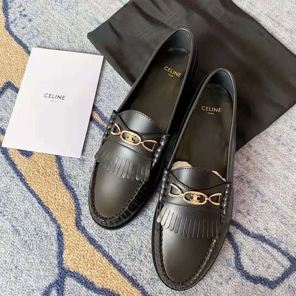 Close-up of gold Maillon Triomphe chain detail on Celine loafer