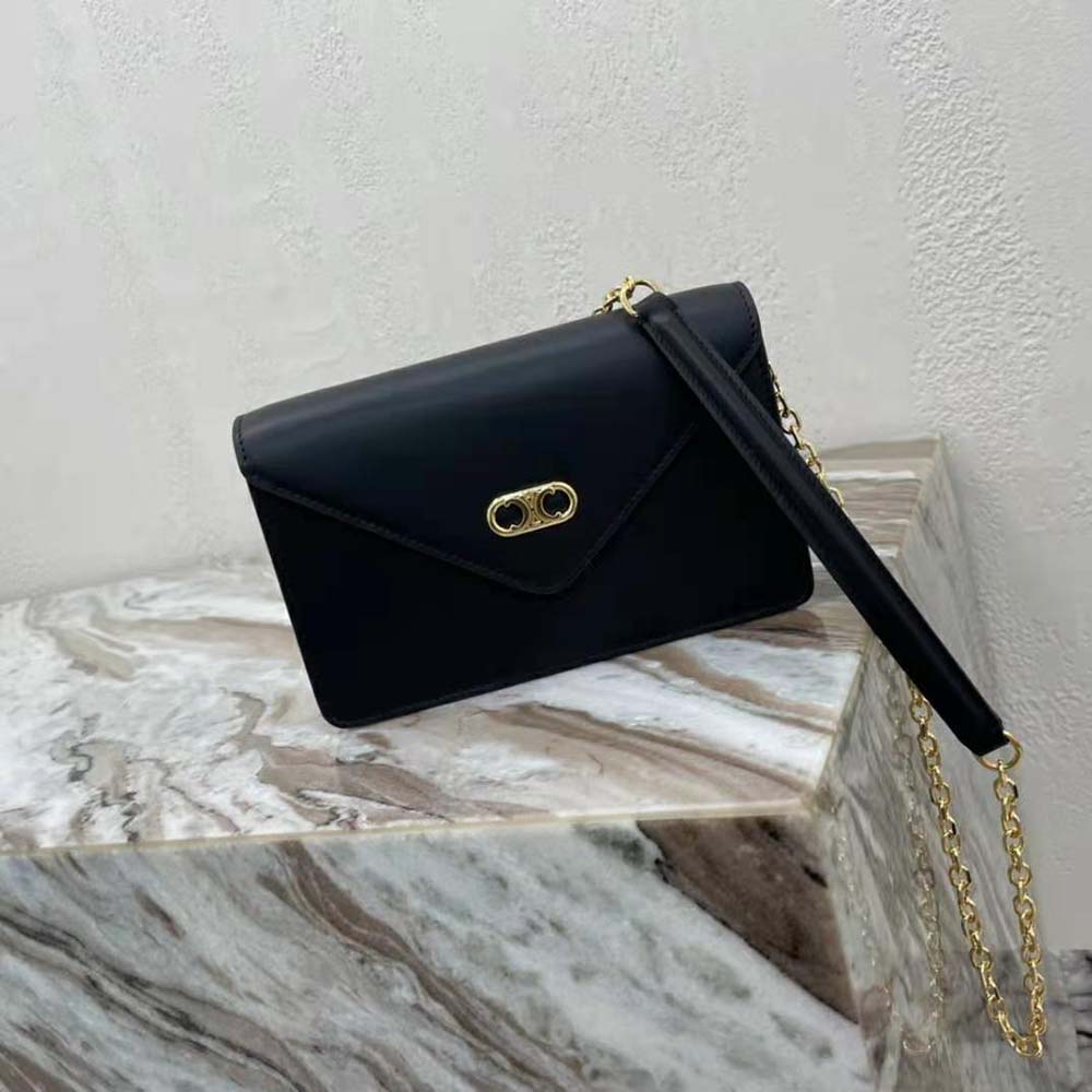 Close-up of gold-tone Maillon Triomphe chain on Celine wallet on chain