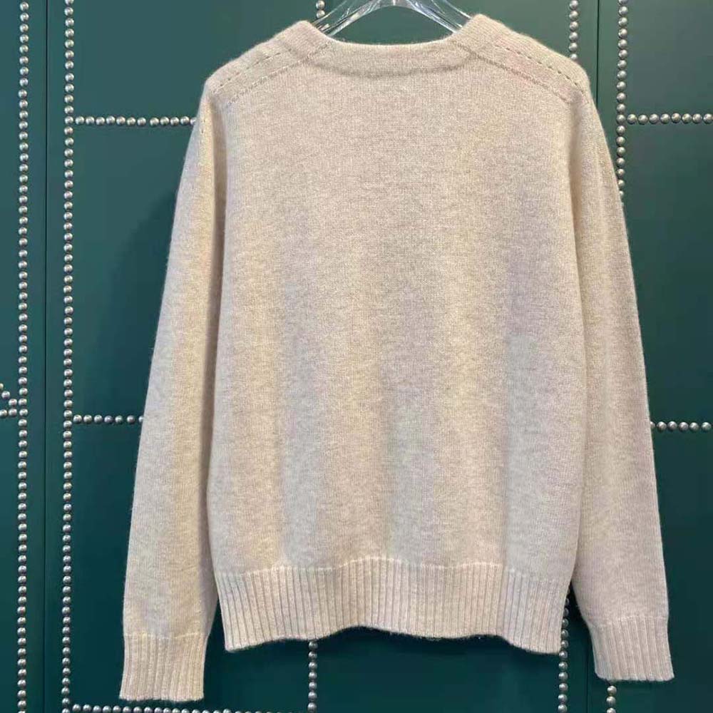 Side profile showing relaxed fit of Celine Women Tunic Sweater in beige