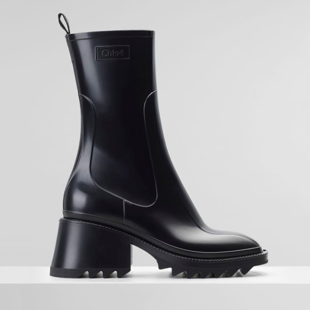 Side profile of Chloe Women Betty Rain Boot in PVC-Black showing sleek mid-calf silhouette