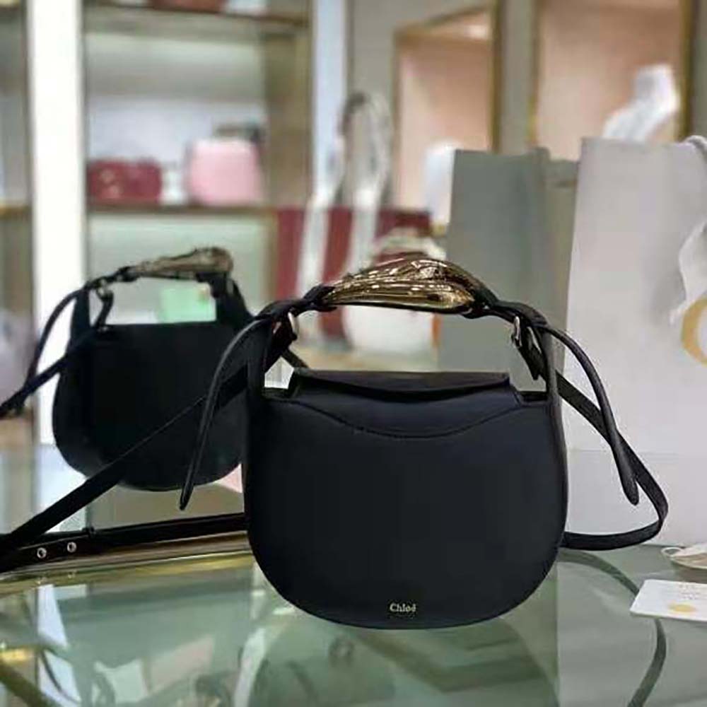 Close-up of gold-tone kiss-lock hardware on Chloe Women Kiss Small Purse