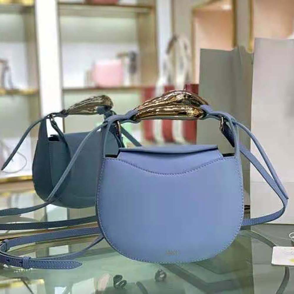 Close-up of gold kiss-lock clasp on Chloe Women Kiss Small Purse