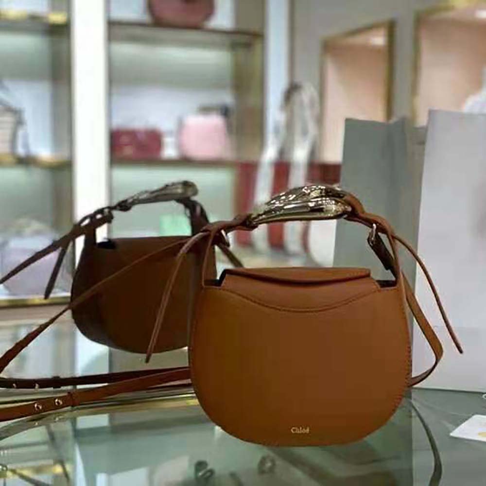 Close-up of gold-tone kiss-lock closure on Chloe Women Kiss Small Purse