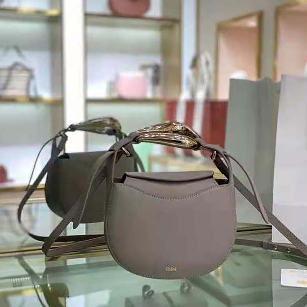 Close-up of gold hardware and magnetic closure on Chloe Women Kiss purse