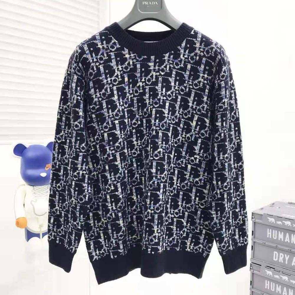 Side angle showcasing fit of Dior Men Oblique Sweater in navy