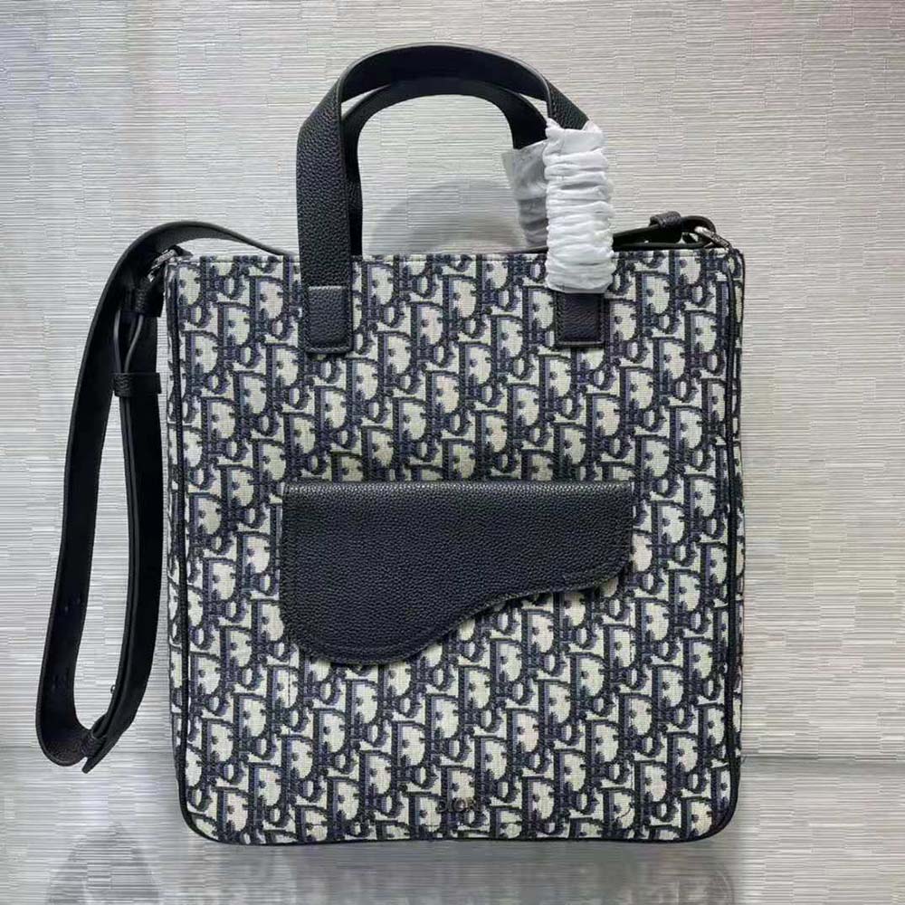 Side angle showing silver hardware and adjustable strap on Dior Men Saddle Tote Bag