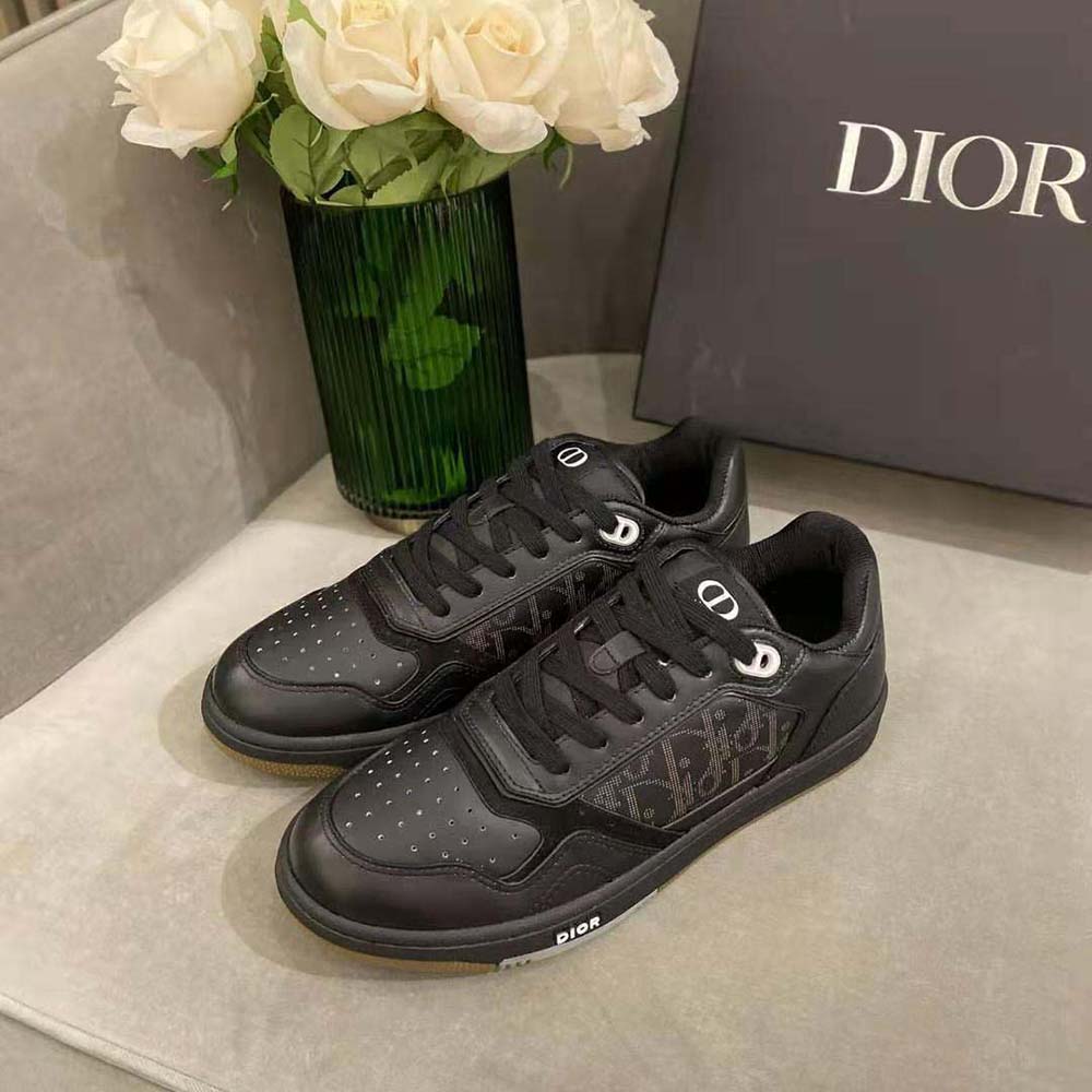 Close-up of black leather and embossed Dior logo on sneaker