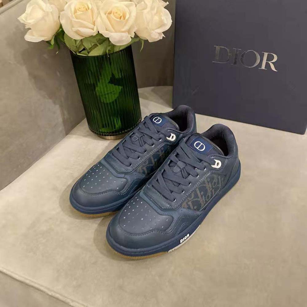 Close-up of navy leather and silver Dior logo hardware