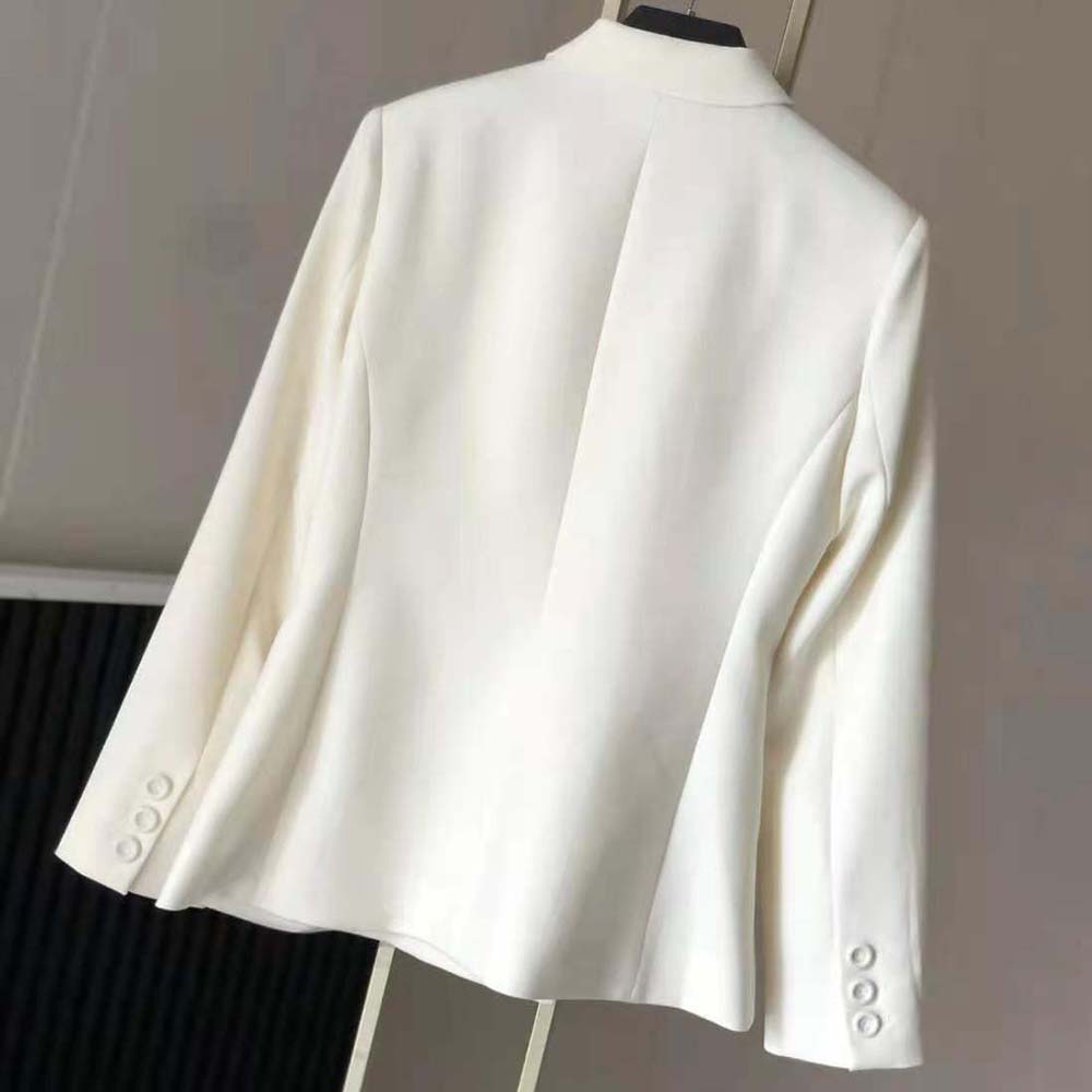 Side profile showing tailored silhouette of Dior Women 30 Montaigne Bar Jacket