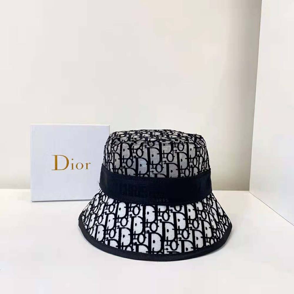 Close-up of Dior logo embroidery on blue bucket hat brim