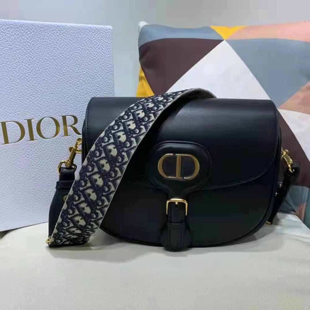 Close-up of silver-tone Dior hardware on the black leather bag