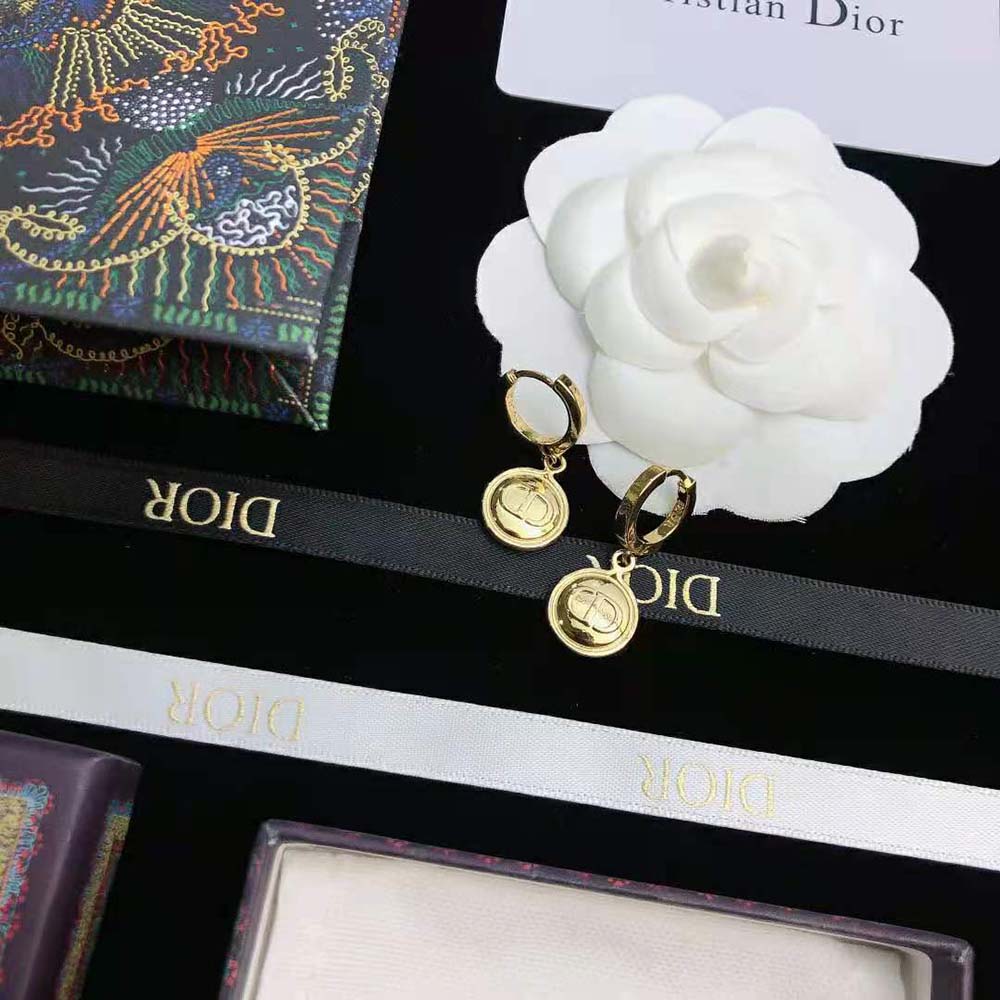 Side angle showing the smooth gold finish of Dior Women Petit CD Earrings