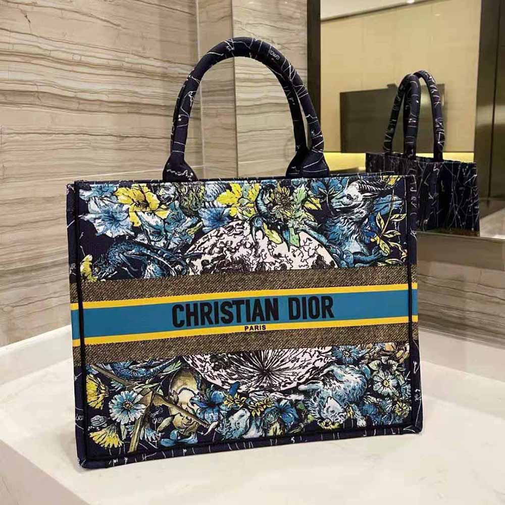 Side angle showing silhouette and silver hardware of Dior Women Small Dior Book Tote Blue