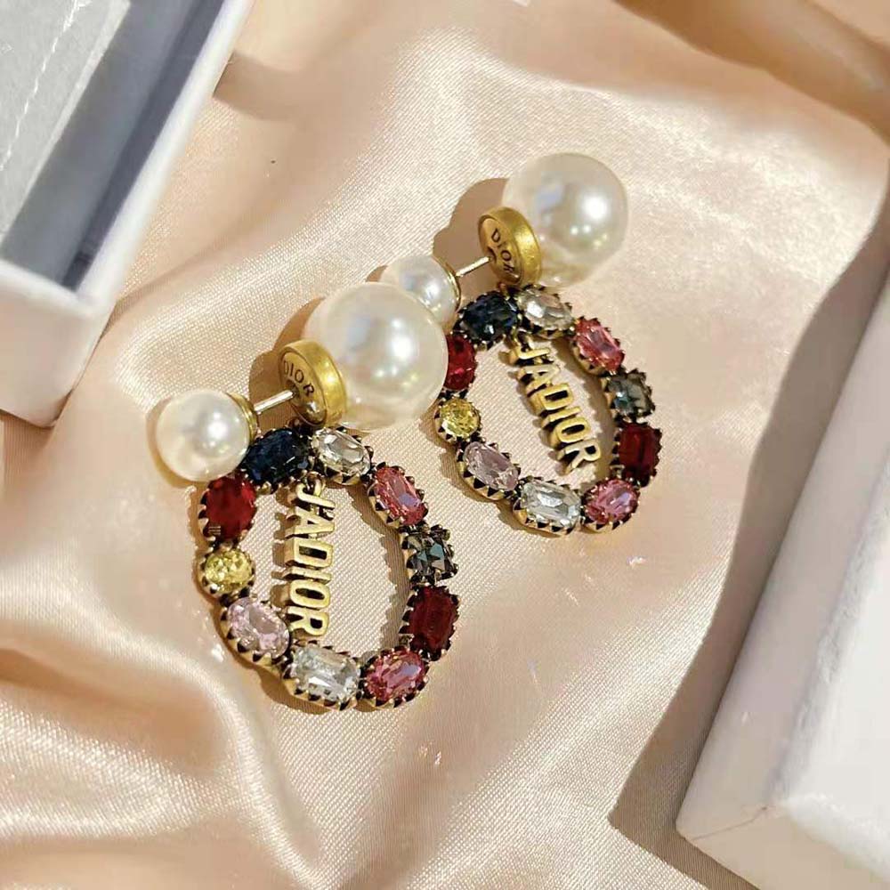 Close-up detail of Dior logo on Tribales Earrings in antique gold