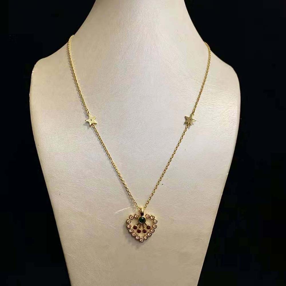 Close-up detail of gold-finish metal and multicolor crystals on necklace