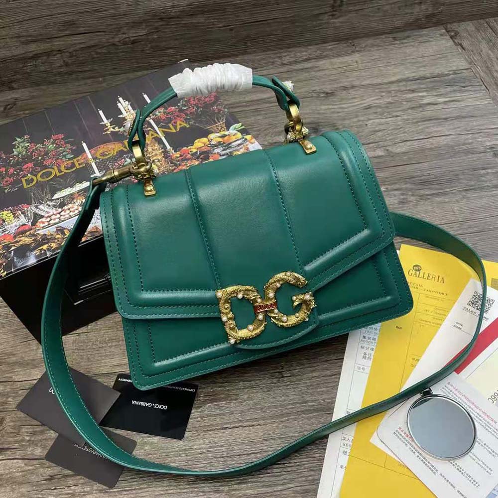 Close-up of gold D&G logo hardware on Amore Bag green leather flap