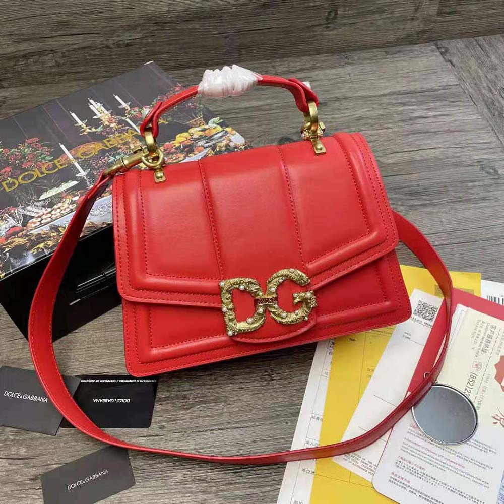 Close-up of gold-tone D&G logo on red calfskin Amore Bag
