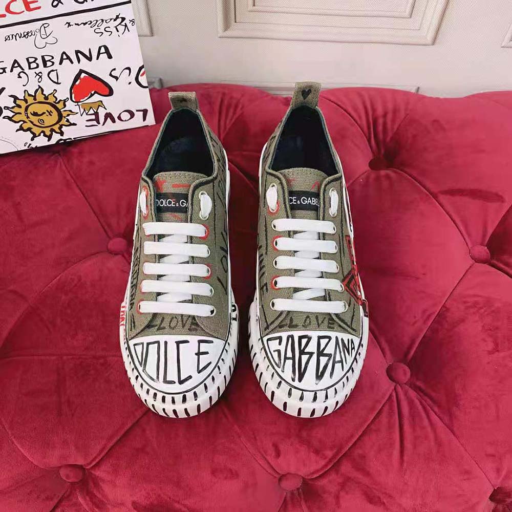 Close-up on green canvas and hand-painted graffiti detail of Dolce Gabbana D&G sneakers