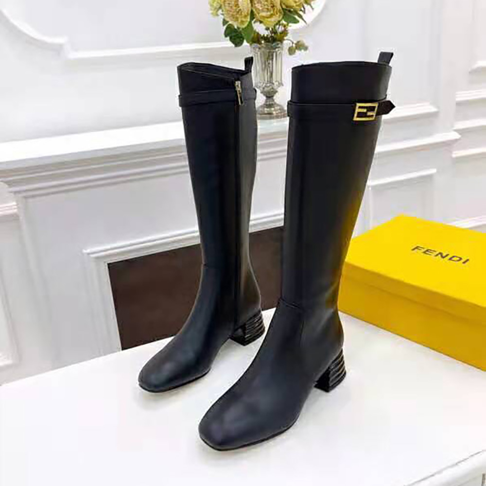 Close-up of Fendi logo hardware on black calfskin leather boots