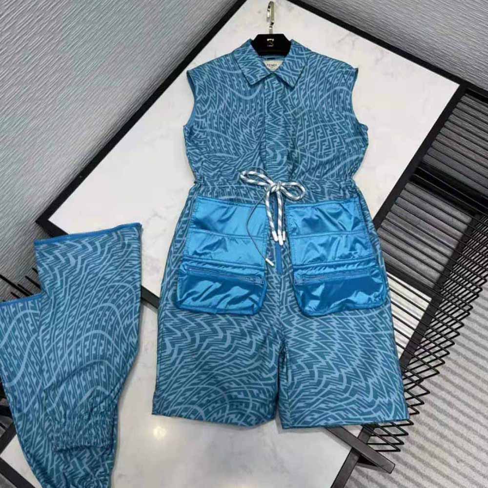 Close-up of signature Fendi logo hardware on light blue denim jumpsuit