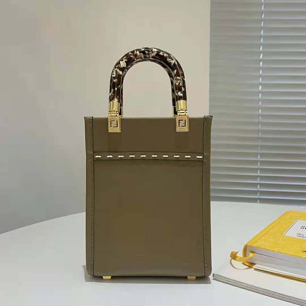Side angle showing texture contrast of leather and elaphe on Fendi mini-bag