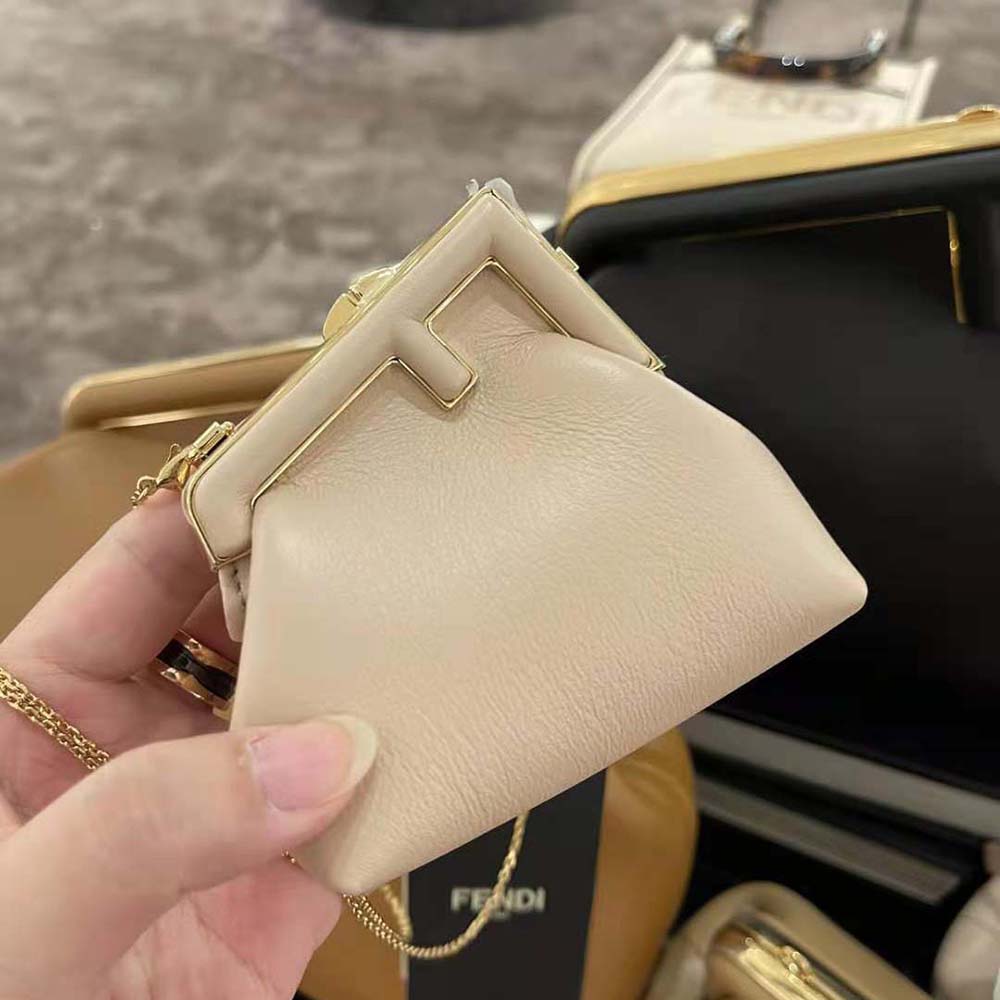 Close-up on gold-tone charm detail of Nano Fendi First Charm bag