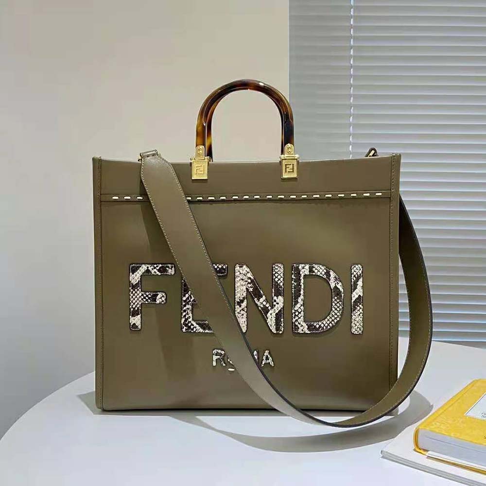Close-up on gold-tone hardware and elaphe detail of Fendi Sunshine shopper