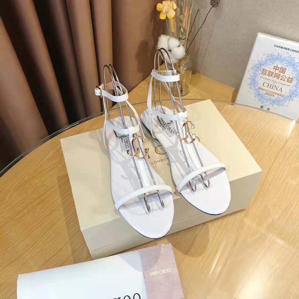Close-up of white patent and nappa leather detail on Jimmy Choo Alodie Flats