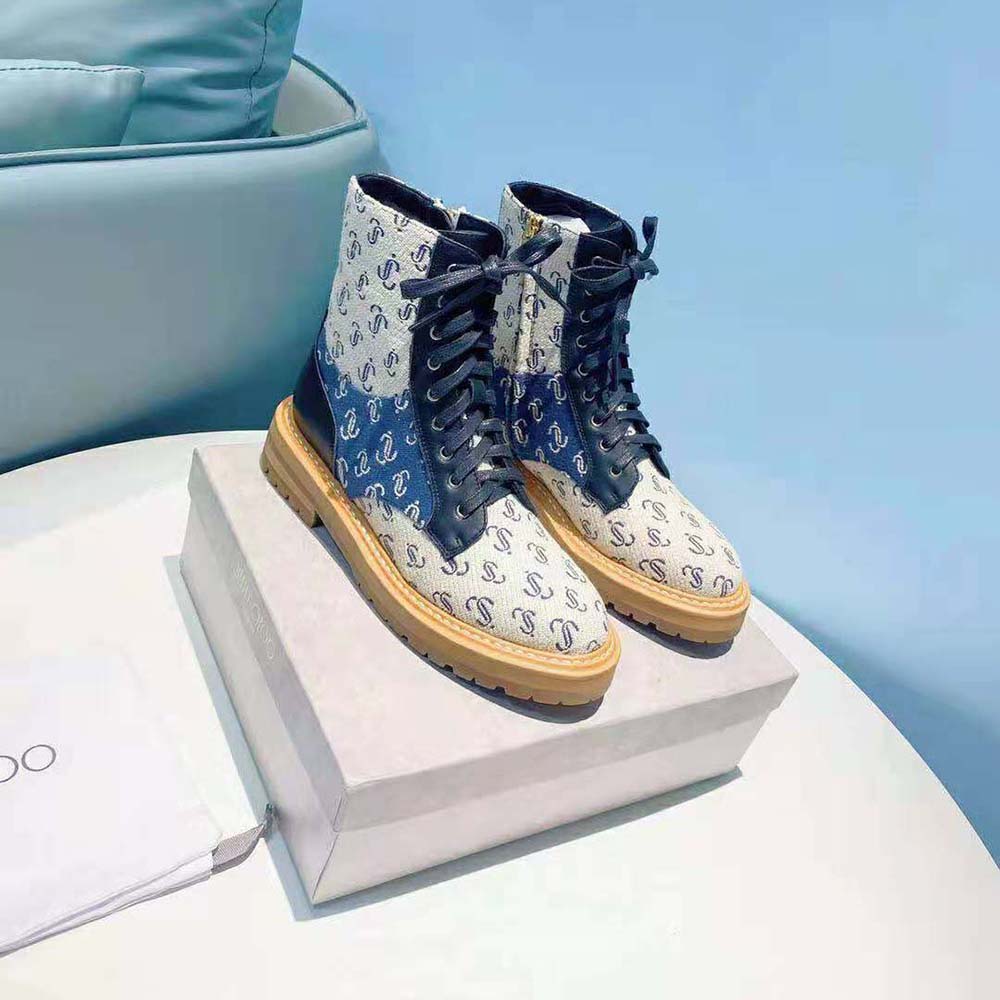 Close-up of JC Monogram jacquard fabric and leather mix on boots