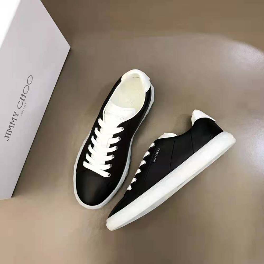 Top view showing black laces and leather texture on Jimmy Choo low-top trainers