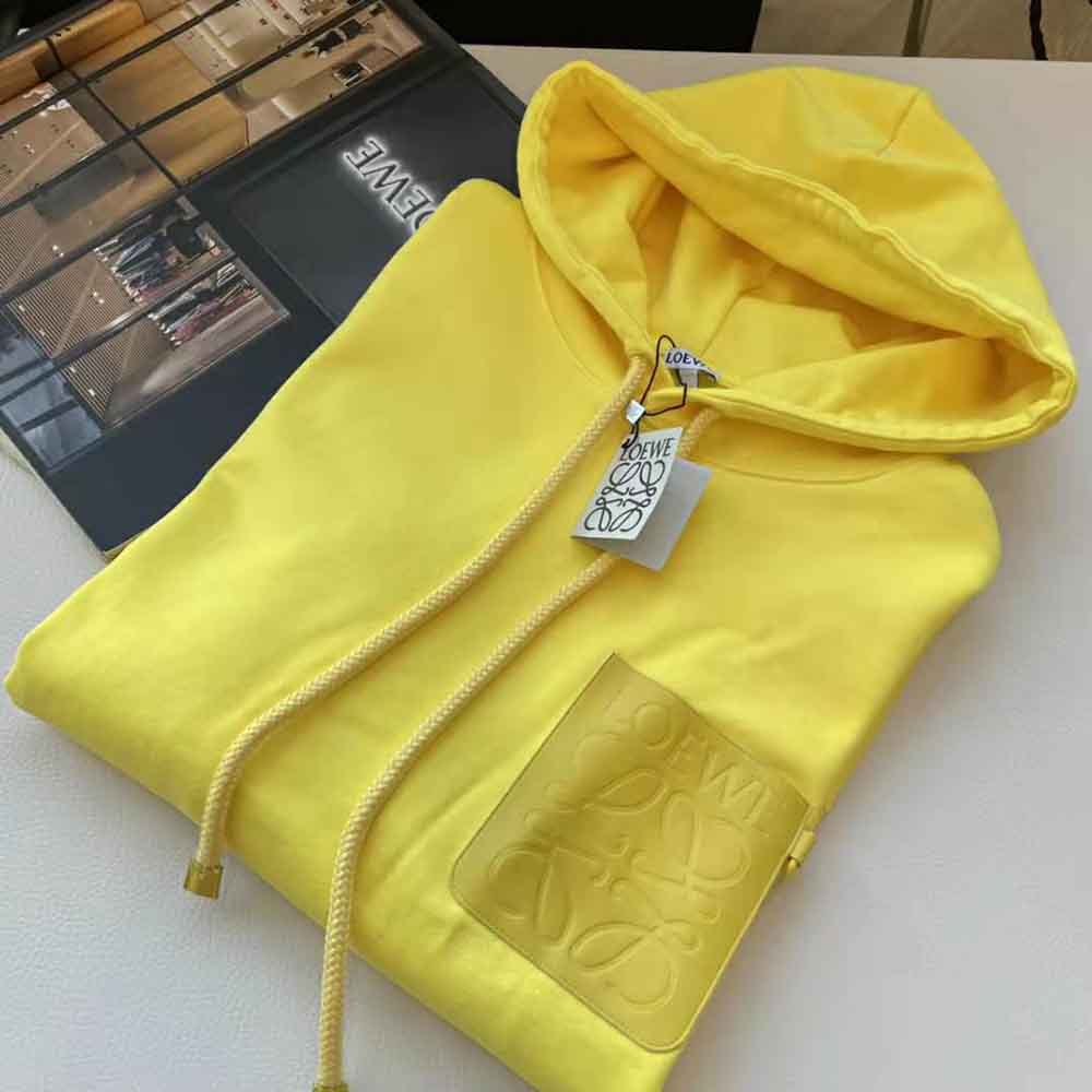 Close-up of Loewe Anagram patch detail on Cotton-Yellow hoodie