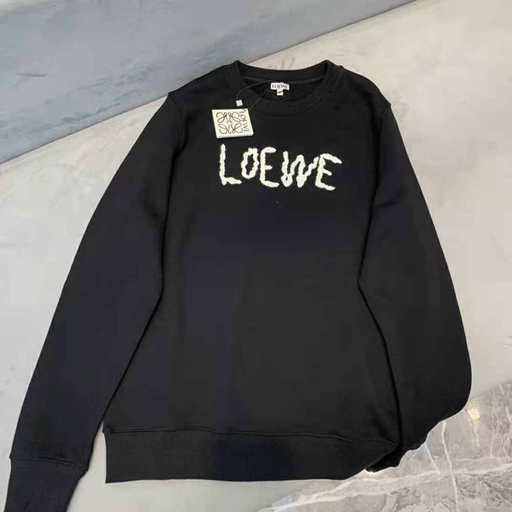 Close-up of Loewe embroidery detail on black cotton sweatshirt