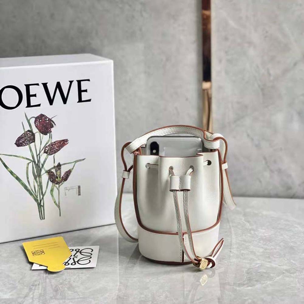 Side profile showing silhouette of Loewe Women Nano Balloon Bag in white