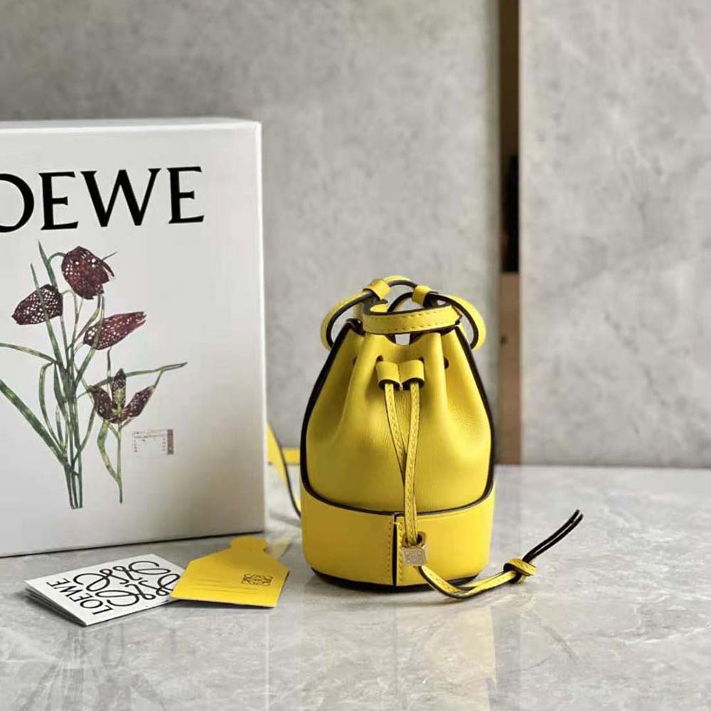 Close-up of yellow leather and gold hardware on Loewe Women Nano Balloon Bag
