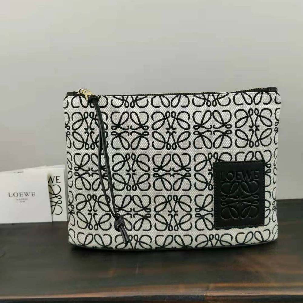Side angle showing textured jacquard and sleek black calfskin on Loewe pouch