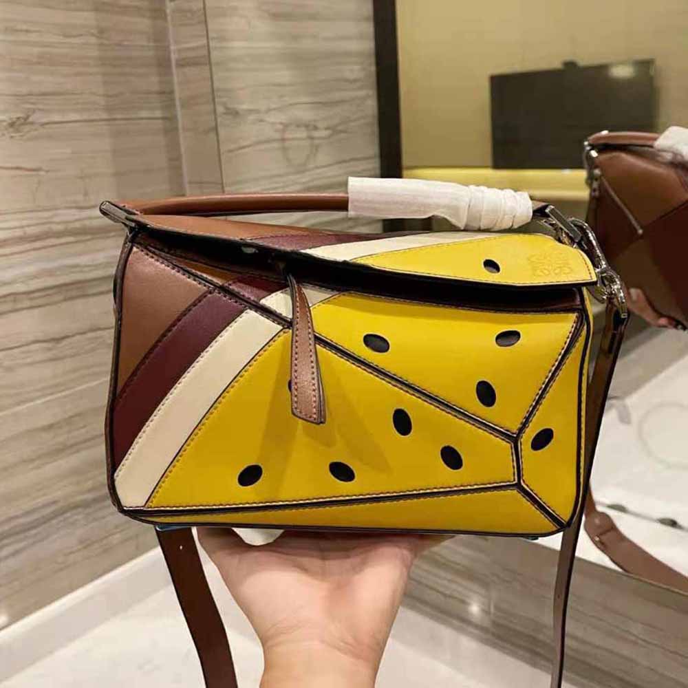Side angle showing structured silhouette of Loewe Passion Fruit Mini Puzzle Bag