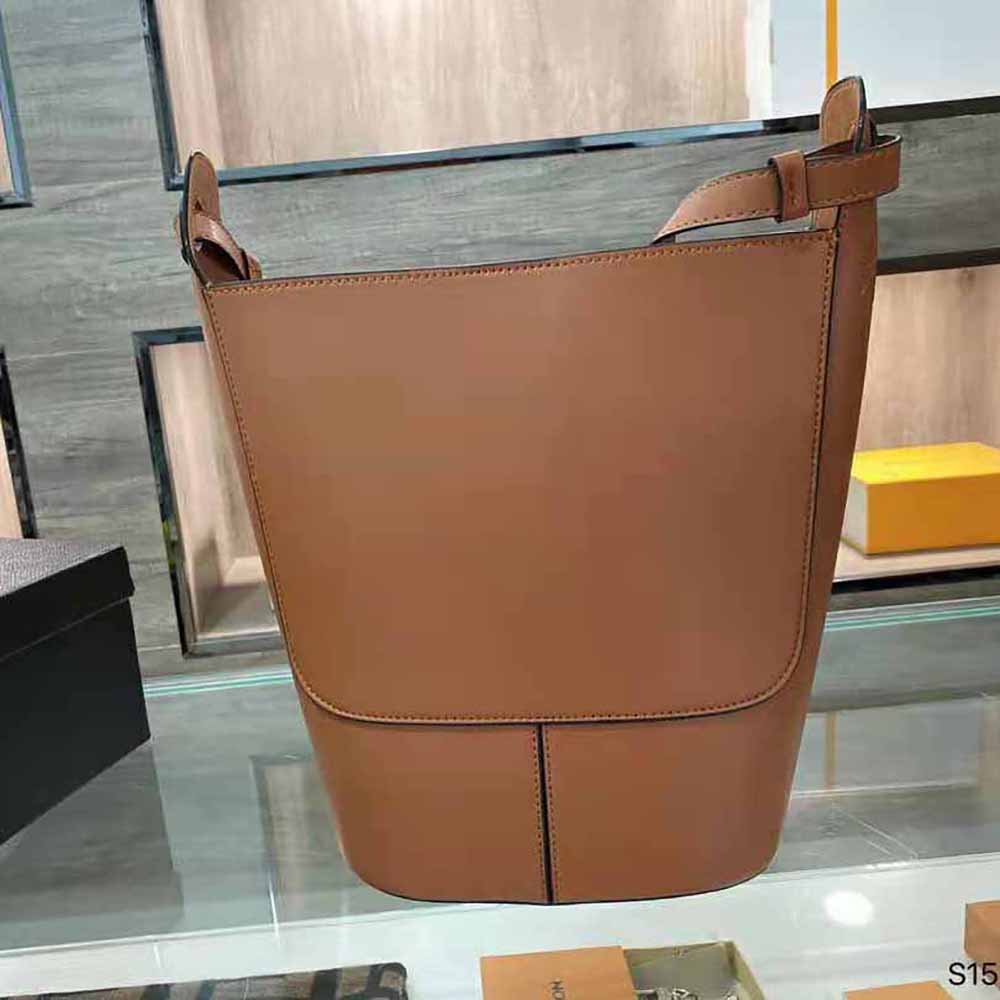 Side angle showing curved shoulder strap and silhouette of Loewe Small Hobo Anagram Bag