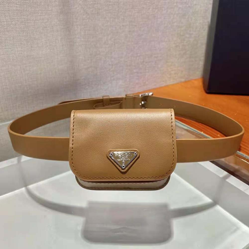 Close-up of Prada logo and gold-tone hardware on brown leather belt