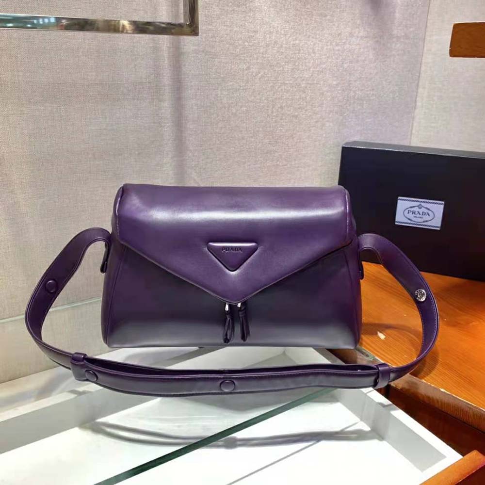 Side angle showcasing padded texture of Prada Signaux Bag in purple
