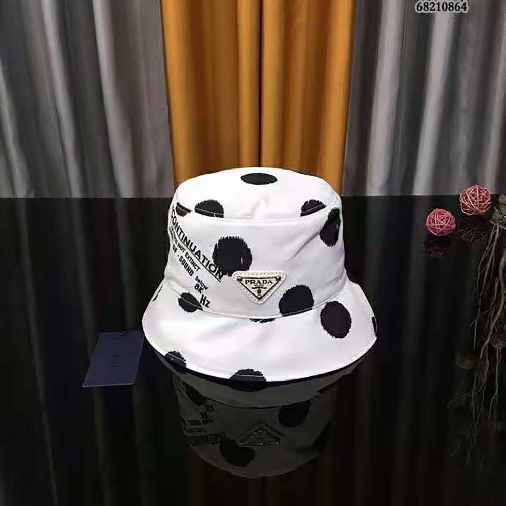 Close-up of printed logo detail on white Prada Re-Nylon bucket hat