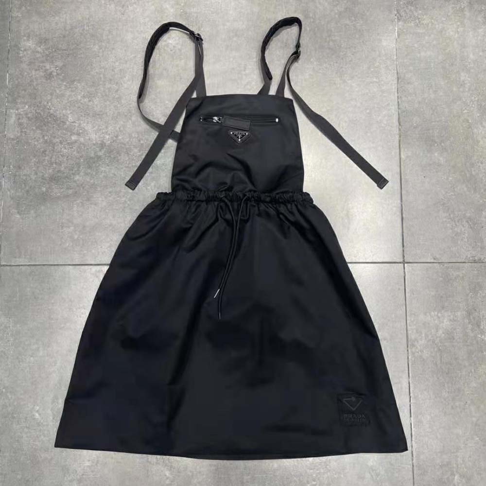 Close-up of Prada logo hardware on Re-Nylon pinafore dress